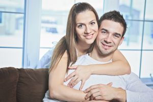 An happy couple at home relaxing in sofa